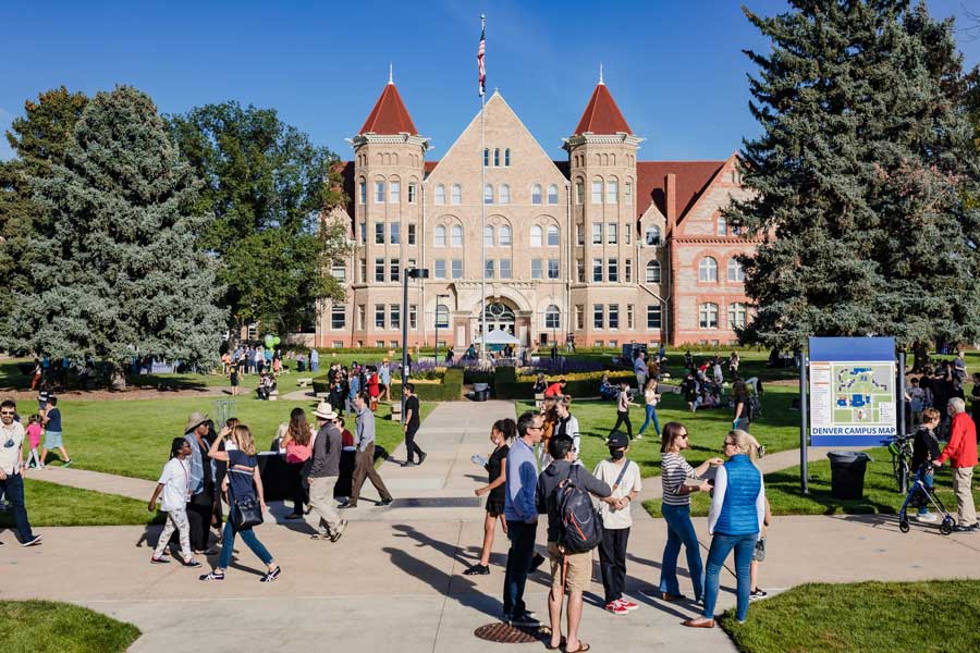 Students walking on paved pathway in front of Mosaic Community Campus