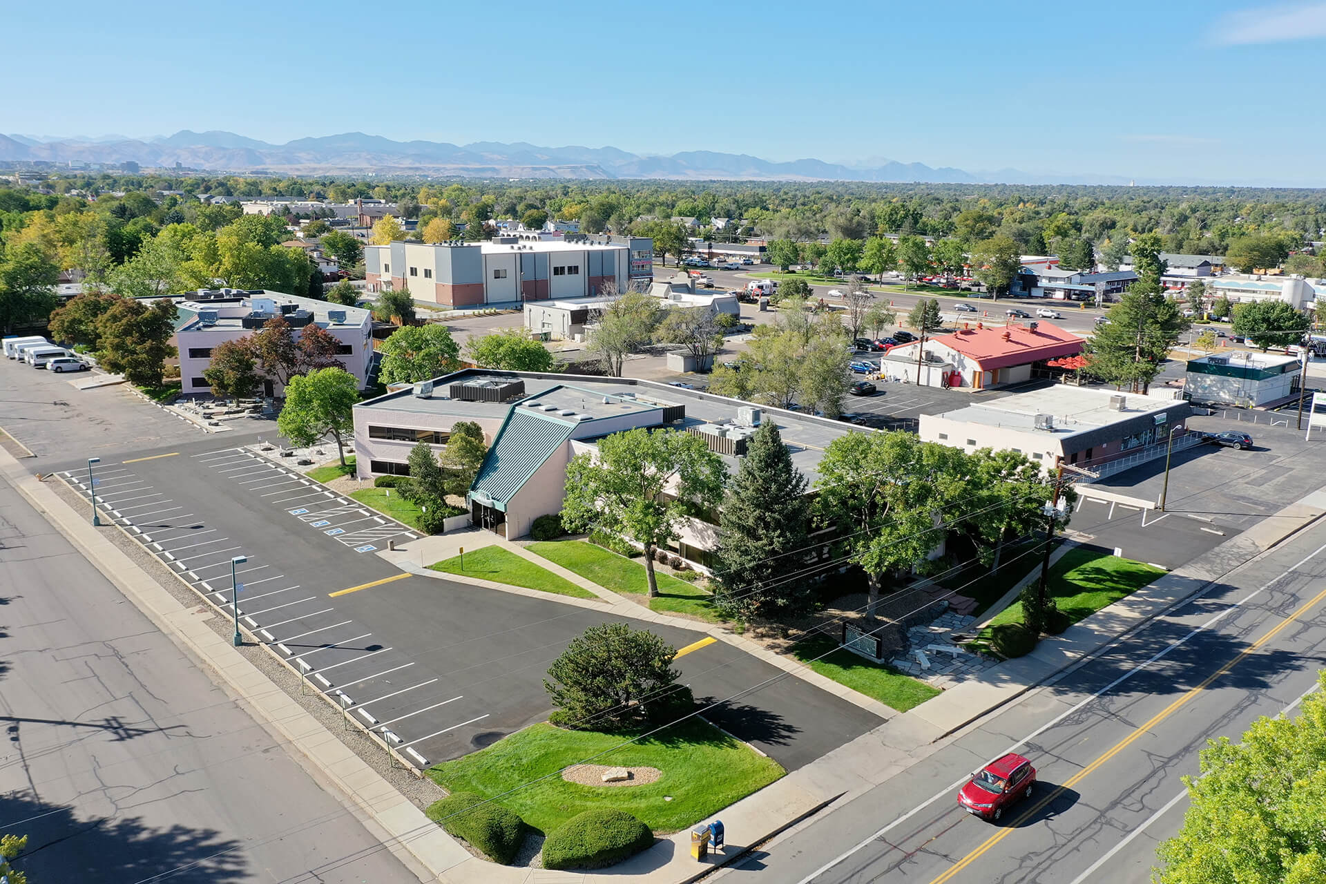 Aerial view of parking lot and skyline, Harlan Nonprofit center a 1-story building in the center