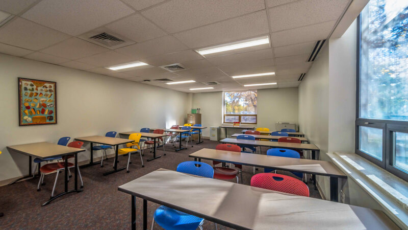 Empty classroom with blue and red chairs