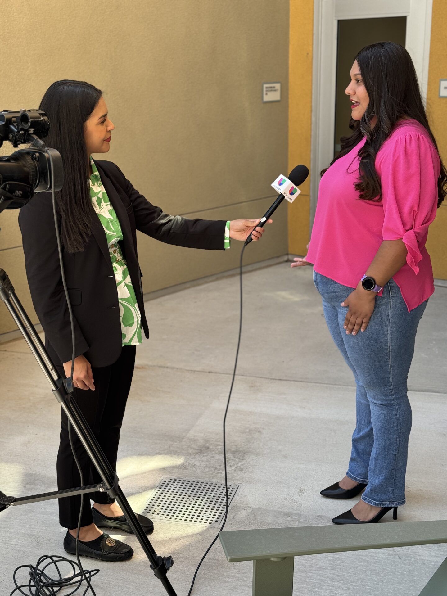Arely Garcia, a new resident of South Platte Crossing Apartments, speaks with a Univision reporter during the grand opening celebration in Commerce City.